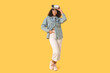 © Pixel-Shot - Young African-American woman with VR glasses on yellow background