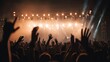 © Yothin - Crowd Hands Raised Cheering Energetic Stage Lights Warm Orange Glow Concert Atmosphere Celebration