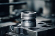© Andrew S. - Detailed View of a Precision Machined Metal Piston Component in a Workshop