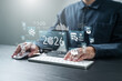 © Sansert - Business growth goals concept for 2026. Businessman working on laptop with 2026 year, target icon and business growth symbol. Strategic planning challenge and future success.