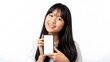 © Hamza - Asian woman holding smartphone with blank screen and smiling at camera on white background, technology and communication concept