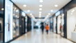 © Ofida Studio - Blurred Modern Shopping Mall Interior with Abstract Lights and People