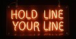 © antishock - Bright neon sign displays text hold line your line against dark background. Rectangular shape, warm glow, simple design.