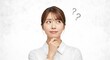 © Logo - Young Asian woman pondering with question marks above her head.