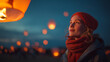 © Tetyana - Young woman releasing a sky lantern, smiling with hope and looking up at the evening sky, celebrating a festival of light and wishes during a winter night, copy space