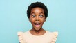 © Iuliia - African american child surprised with wide eyes and open mouth. Emotional expression of reaction, amazement, or shock for advertising and kids content.