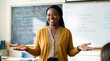 © ArtMajestic - Black woman teacher with dreadlocks standing in classroom with open arms and smiling. Education and welcoming learning environment