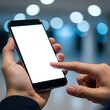 © Hayyat - Close-up of human hands holding and interacting with a modern smartphone, featuring a blank white screen ready for custom content, against a softly blurred background with bokeh lights