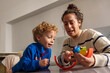 © Javier - Mother and child playing balancing game at home, learning and bonding through educational playtime