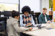 © luisrojasstock - Diverse business team collaborating during an office meeting