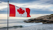 © sefatahmed - Canadian flag waving proudly by the ocean with rocky coastline views