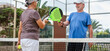 © Daniel - Senior couple playing paddle tennis or padel, outdoors in padel court enjoying and having fun together. Mature woman and old man high five after finish game