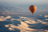 Hot air balloon over desert dunes