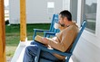 © Matt Fowler KC - Middle Aged Male Information Technology Worker Taking a Mindful Digital Detox Reading Book Outside of Home on Porch Concept