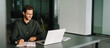 © Stock 4 You - Middle-age European man using laptop computer for business studying, watching virtual webinar training writing notes. Focused young Latin businessman student working in office. Web banner, copy space