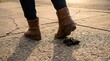 © agrope - A shoe hovers just above a pile of dog feces on an urban sidewalk, capturing an awkward urban moment.