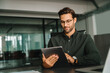 © Stock 4 You - European young man working on trade online using touchpad fintech computer for business work at workplace. Focused Latin entrepreneur businessman holding digital pc tablet sitting in company office
