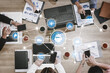 © InfiniteFlow - A dynamic business team engages in strategic brainstorming using mobile devices and technology in a modern workspace, fostering innovation and collaboration. Tessel