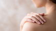 © Nakarin - Soft close up of hands gently touching shoulder with smooth skin and natural light creating calm and soothing mood
