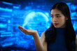 © BuabarnCH - Futuristic woman interacting with virtual holographic interface, touching transparent digital screens in blue cyber environment, data controly, immersive human computer interaction.
