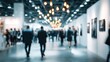 © afdal - Blurred indoor exhibition hall with illuminated hanging lights and people walking