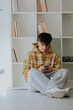 © carballo - young man with mobile phone at home in casual outfit