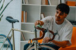 © carballo - young man cleaning or preparing vintage bicycle