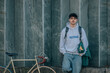 © carballo - young man on street wall with vintage bicycle and copy-space
