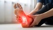 © Artfinity - Human foot with red glowing pain inflammation. Healthcare and podiatry concept. Person sitting on the floor holding a painful ankle with visible skeletal bone structure