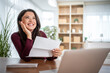 © Migma_Agency - Woman receiving good news letter and smiling joyfully
