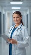 © Tanvir Rahman  - Smiling young female doctor with tablet in modern hospital corridor