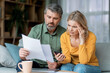 © Prostock-studio - Budget Planning. Stressed Middle Aged Spouses Holding Papers And Calculating Family Spends Together, Thoughtful Mature Spouses Checking Documents, Suffering Financial Crisis, Closeup Shot
