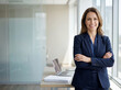 © Five Million Stock - Beautiful hispanic senior business woman with crossed arms smiling at camera. European or latin confident mature middle age leader female businesswoman standing at office workplace, copy space.