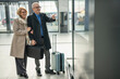 © Jelena - Senior couple checking travel information at airport