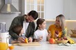 © New Africa - Happy family cooking together at table in kitchen