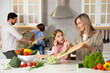 © New Africa - Happy family cooking and having fun together at table in kitchen