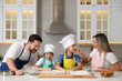 © New Africa - Happy family cooking and having fun together at table in kitchen