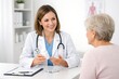 © Bellal Mollik - Smiling Female Doctor Consulting Elderly Patient and Explaining Medication in Medical Office