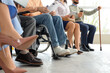 © Pixel-Shot - Job applicants with man in wheelchair waiting for interview at office