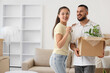 © Pixel-Shot - Young couple with key from their new house and box on moving day