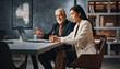 © Rajesh - Diverse business professionals collaborating on a laptop in a modern office setting