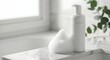 © antuanetto - White facial cleansing foam overflowing on a pristine bathroom sink with natural light for a fresh skincare concept