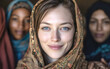 © Surachetsh - Muslim woman wearing a hijab looks directly at the camera. The soft background highlights her calm expression and modern style.