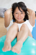 © auremar - woman doing abdominal exercises on an aerobic ball