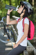 © auremar - a female cyclist drinking water