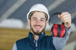 © auremar - happy young worker with earmuffs in noise cancelling concept