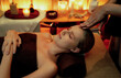 © InfiniteFlow - Caucasian woman enjoying relaxing anti-stress head massage and pampering facial beauty skin recreation leisure in warm candle lighting ambient salon spa in luxury resort or hotel. Quiescent