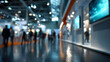 © ABF_MATEO - A bustling convention hall filled with attendees, illuminated by modern displays and ambient lighting, showcasing a diverse range of innovations.