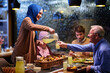© .shock - Family gathers for iftar during Ramadan with food and drinks in a warm atmosphere at a cozy restaurant setting