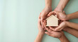 © Gambar - hands holding a small house model